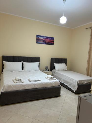 two beds sitting next to each other in a room at Rest House in Vlorë