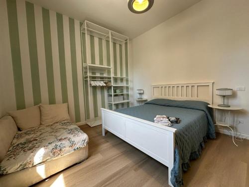 a bedroom with a bed and a couch in it at Eleganza Marina in Livorno