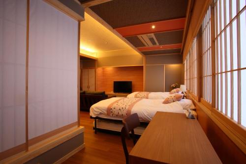 Postel nebo postele na pokoji v ubytování 筑波山江戸屋