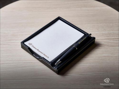 a black cell phone sitting on top of a table at Daiwa Roynet Hotel Morioka in Morioka