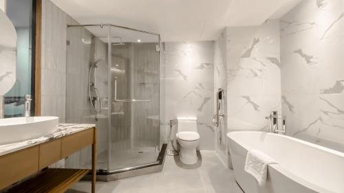 a bathroom with a shower and a toilet and a sink at Krungsri River Hotel in Phra Nakhon Si Ayutthaya