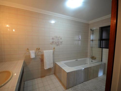 a bathroom with a tub and a sink at Heri guest house in Johannesburg