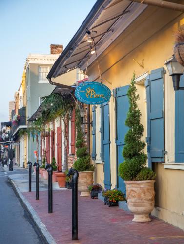 a street with a blue sign on a building at Hotel St. Pierre French Quarter in New Orleans