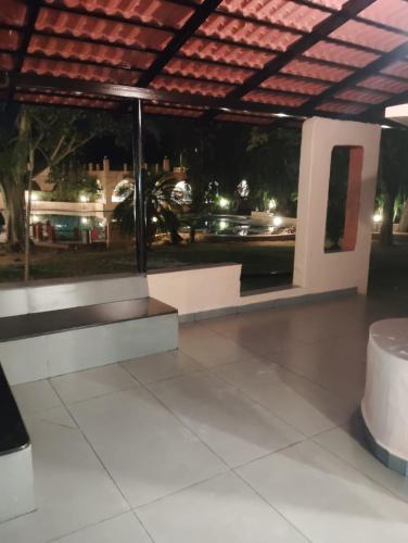 a bench in a building with a view of a street at The Country Club Wildlife Resorts in Bandipūr