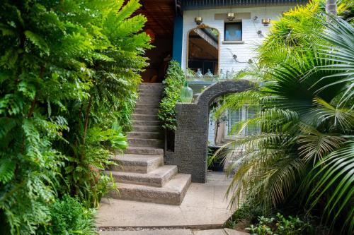 a stairway leading to a house with green plants at La Varangue in Antananarivo