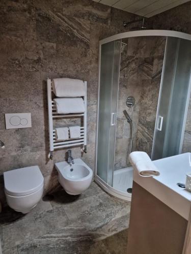 a bathroom with a sink and a toilet and a shower at Palazzo Grandori Alloggi Turistici in Viterbo