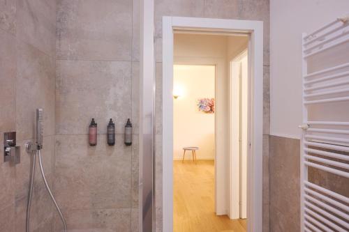 a bathroom with a shower and a walk in shower at Milan Retreats in Milan
