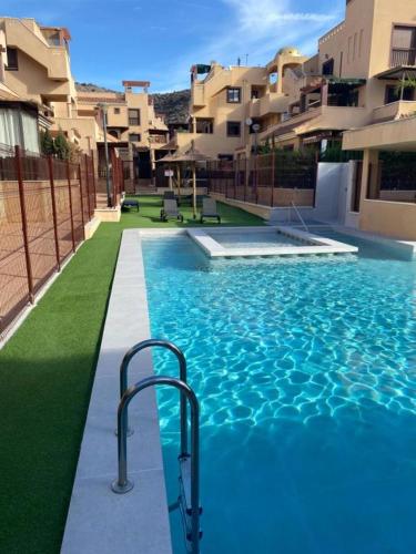 a swimming pool with a hand rail in a building at Ático De Diseño en Aguilas in Águilas