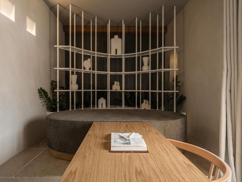 a table with a book on it in a room at The Theodore Boutique Hotel- adults only 16 plus in Agia Marina Nea Kydonias