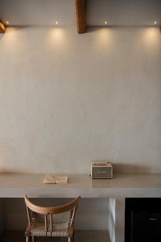 a table with a chair and a radio on it at The Theodore Boutique Hotel- adults only 16 plus in Agia Marina Nea Kydonias