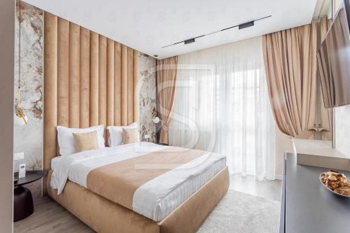 a bedroom with a bed and a large window at Aqua by Kristal Collection in Bucharest