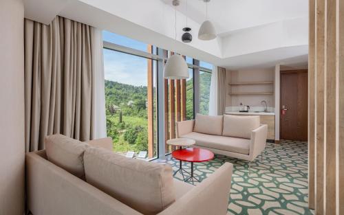 a living room with two couches and a table at Lankaran Springs Wellness Resort in Lankaran