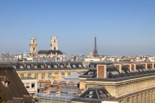 a view of the roofs of buildings in a city at Hôtel Saint Pierre in Paris