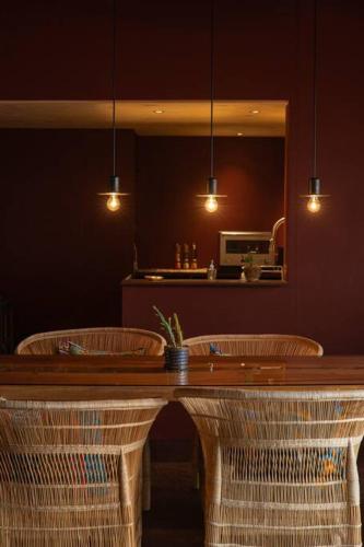 a dining room with a table with two chairs and a mirror at Secret break Hebara in Katsuura