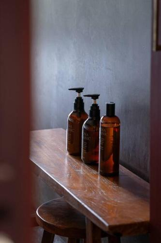 two bottles of soap sitting on a wooden table at Secret break Hebara in Katsuura