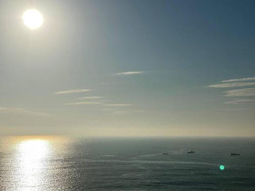 a view of the ocean with the sun in the sky at Secret break Hebara in Katsuura
