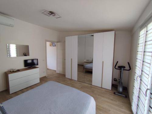 a bedroom with a bed and a mirror at Sweet Home Gaia in Pesaro