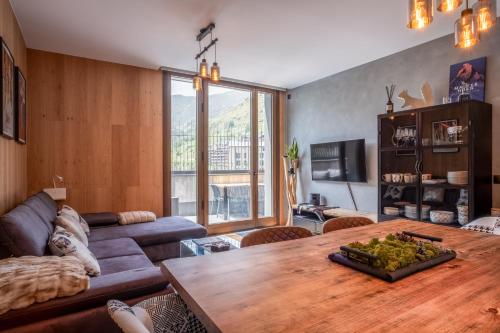 a living room with a couch and a wooden table at ISARD & SPA by SELECT RENTALS in El Tarter