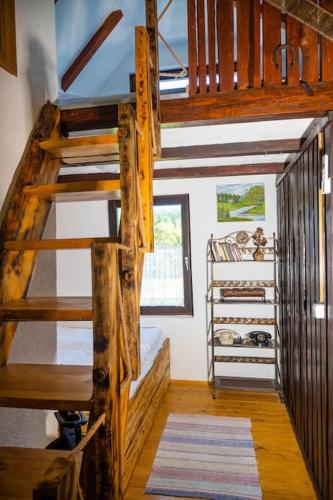 a room with bunk beds and a staircase in a house at Koliba Ravna planina in Pale