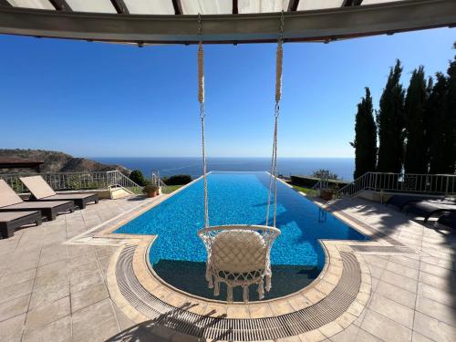 a swing in the middle of a swimming pool at Matteo Villa Limassol Cyprus in Limassol