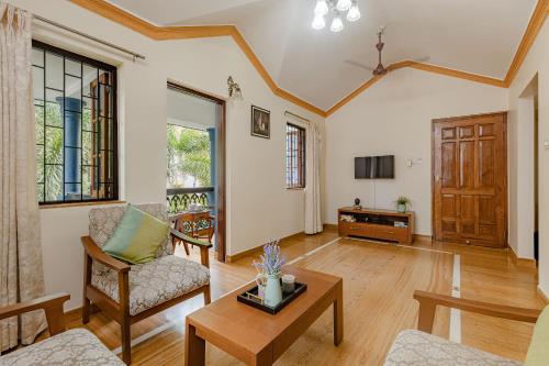 a living room with a couch and a table at Mistral Holidays Near Trinity Beach & Benaulim Beach in Benaulim