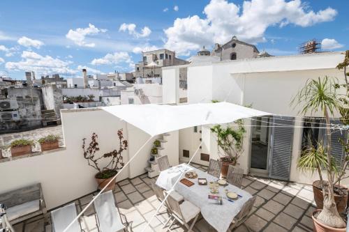a balcony with a table and chairs on a building at Riva Mediterranea in Otranto