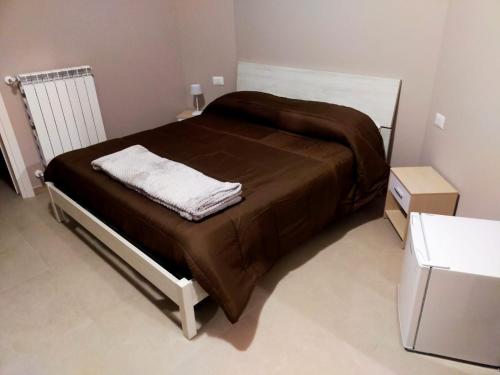 a bedroom with a bed with a brown blanket at ARA HOME Comfort in Marcellinara