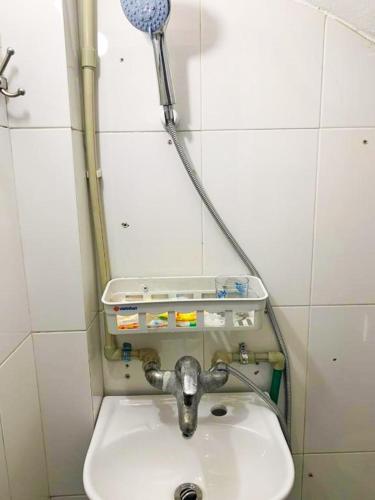 a bathroom with a sink and a shower at Mini Homestay in Hanoi