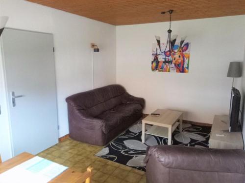 a living room with a couch and a table at Ferienwohnung Noeska 85020 in Ostrhauderfehn