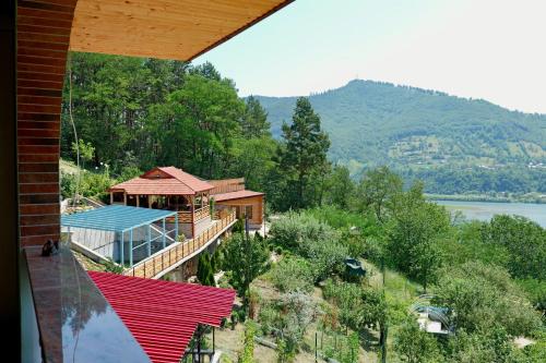 a house on a hill with a view of a lake at Vila Victoria in Pangarati