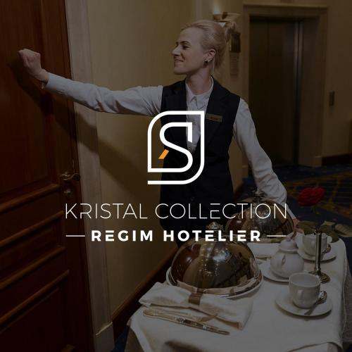 a woman standing in front of a table in a restaurant at Aqua by Kristal Collection in Bucharest