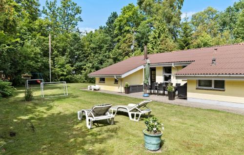 a yard with two chairs and a basketball hoop at Lovely Home In Glesborg With Sauna in Glesborg
