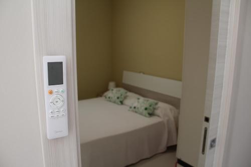 a room with a bedroom with a bed and a mirror at Casa Marina 44 in Marina di Ragusa