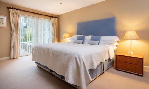 Un dormitorio con una cama grande y una ventana grande. en Underscar - Beckstones, en Keswick