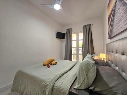 a bedroom with a bed with a teddy bear on it at Fantástico Apartamento VILLA VICTORIA in Adeje