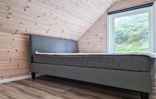 a bed in a room with a window at Amazing Home In Haugesund in Haugesund