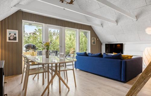 a living room with a blue couch and a glass table at Awesome Home In Toftlund With Wifi in Toftlund