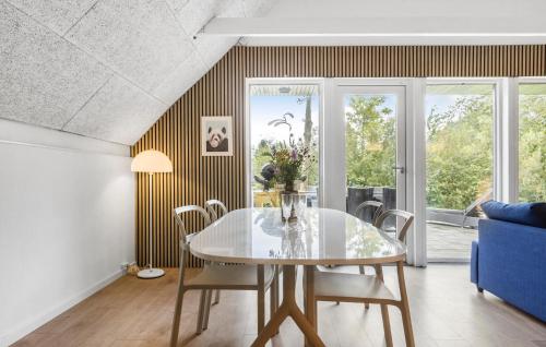 a dining room with a glass table and a blue couch at Awesome Home In Toftlund With Wifi in Toftlund