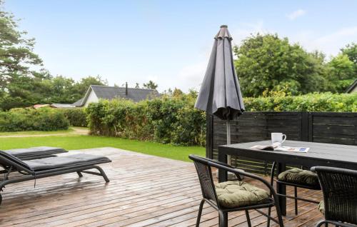 a patio with an umbrella and a table and chairs at Awesome Home In Hemmet With Wifi in Hemmet