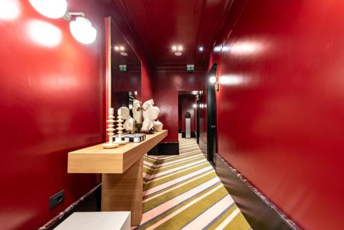 a hallway with red walls and a red hallway with a counter at The Couper Umiltà in Rome