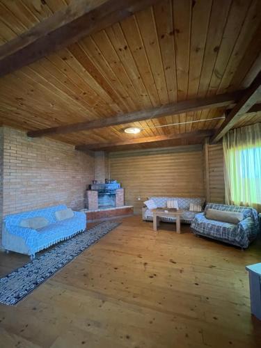 a room with three beds and a wooden ceiling at Villa in Ureki