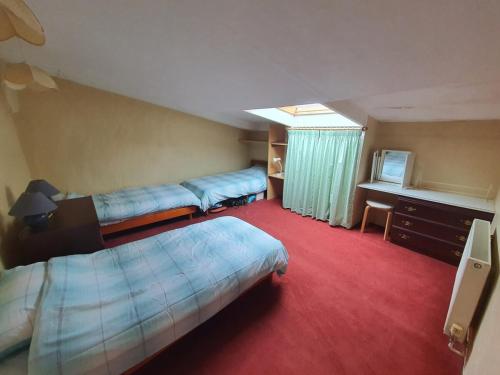 a hotel room with two beds and a television at La Ville Hello, A Spacious House, Sleeps 9, In Rur in Guillac