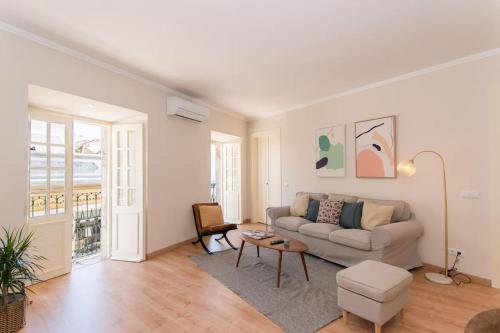 a living room with a couch and a table at Casa Telhados Centro Histórico Terraço Privado in Tavira