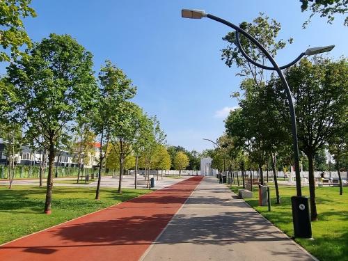 a path in a park with a street light and trees at Aqua by Kristal Collection in Bucharest