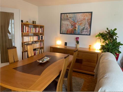 - un salon avec une table et une étagère dans l'établissement Apt 2 pièces, vue admirable, localisation exceptionnelle à 20 mn de Paris, à Noisy-le-Grand
