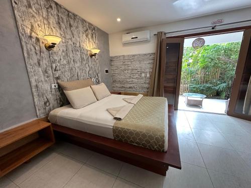a bedroom with a bed with a wooden wall at Pousada Oasis Paracuru in Paracuru