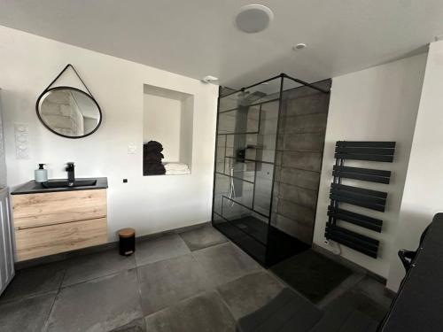 a bathroom with a shower and a sink and a mirror at Maison de charme, pierres blanches, SPA Jaccuzi in Camblain-lʼAbbé
