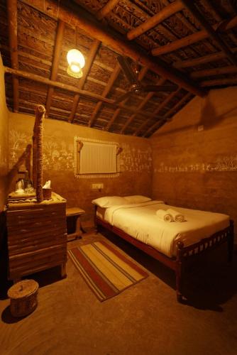 a bedroom with a bed and a sink in a room at The Soul Marayoor Mudhouse - Munnar in Marayoor