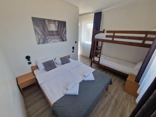 a bedroom with two beds and a bunk bed at Vurk INN Paracin in Paraćin