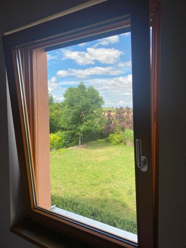 a window with a view of a field of grass at SECRA Exclusive Maisonette-Ferienzimmer Am Backhausgarten in Flonheim
